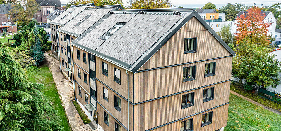 A house “retrofitted” to net-zero standards by ecoworks ecoworks net-zero panels on an apartment building.